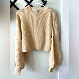 Buckle. Bell sleeve sweater.